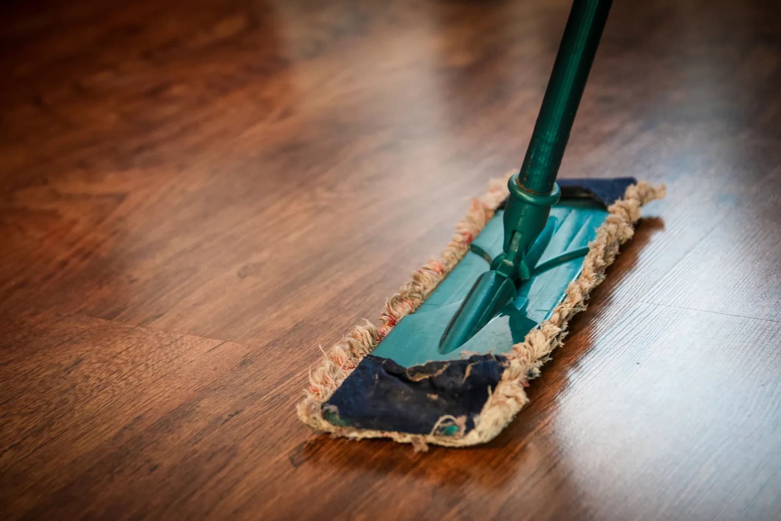 A flat mop gliding across a polished hardwood floor